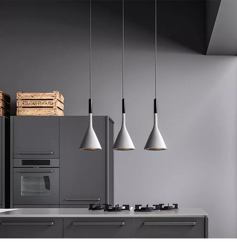 Modern Scandinavian style pendant light shown in white hanging over kitchen Island