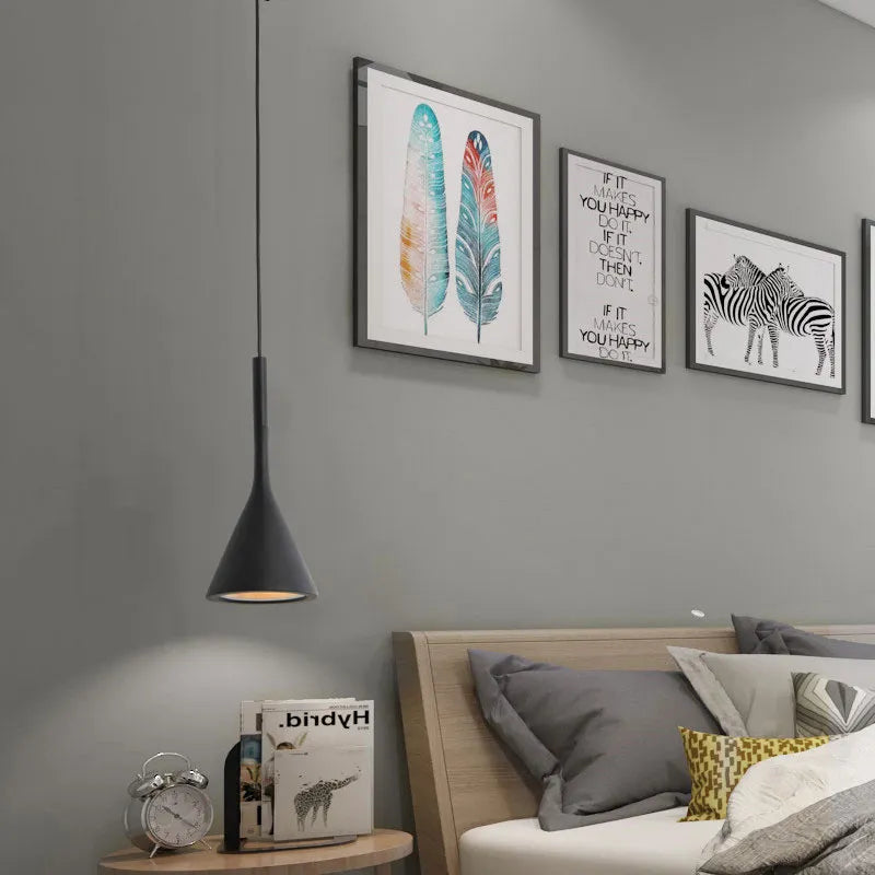 Scandinavian style pendant light in black shown at bedside