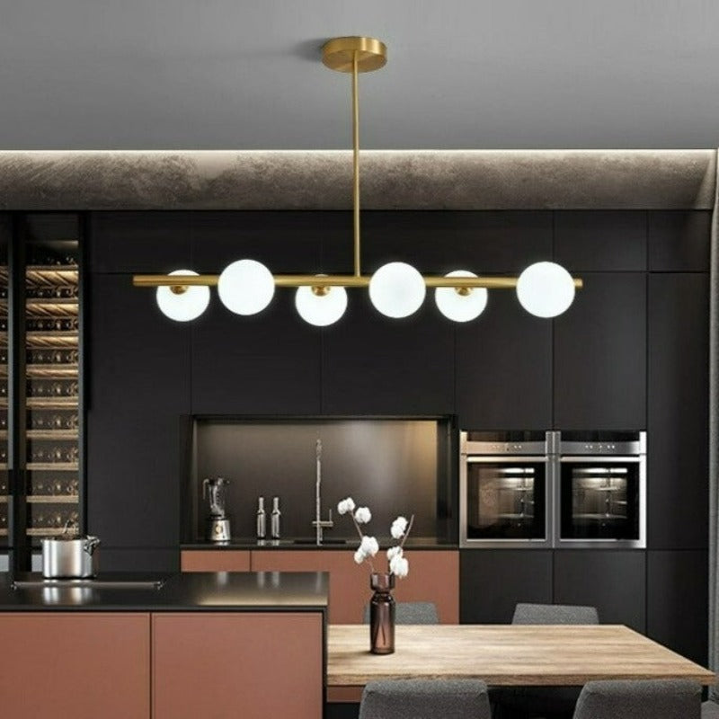 Six globe modern horizontal chandelier shown over a kitchen island