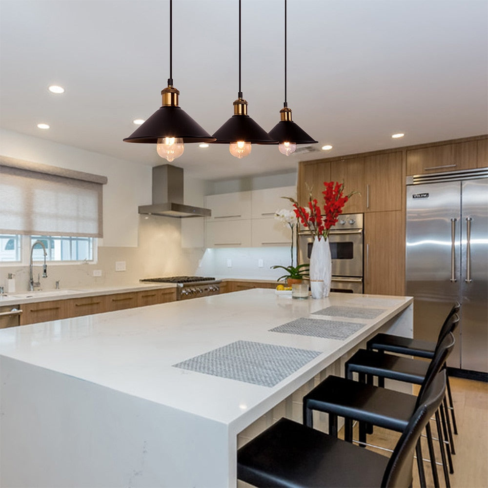 Three Black vintage style hanging pendant cafe lights with edison bulb hanging over kitchen island