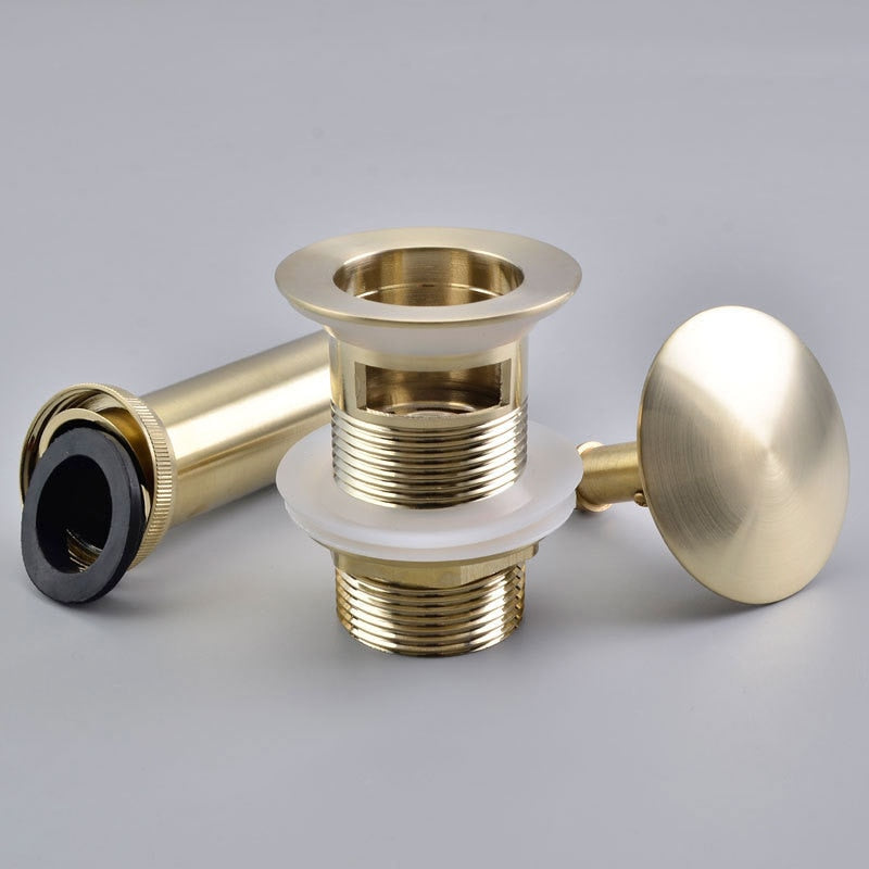 Detailed images of pop up, push down bathroom sink drain in brushed gold