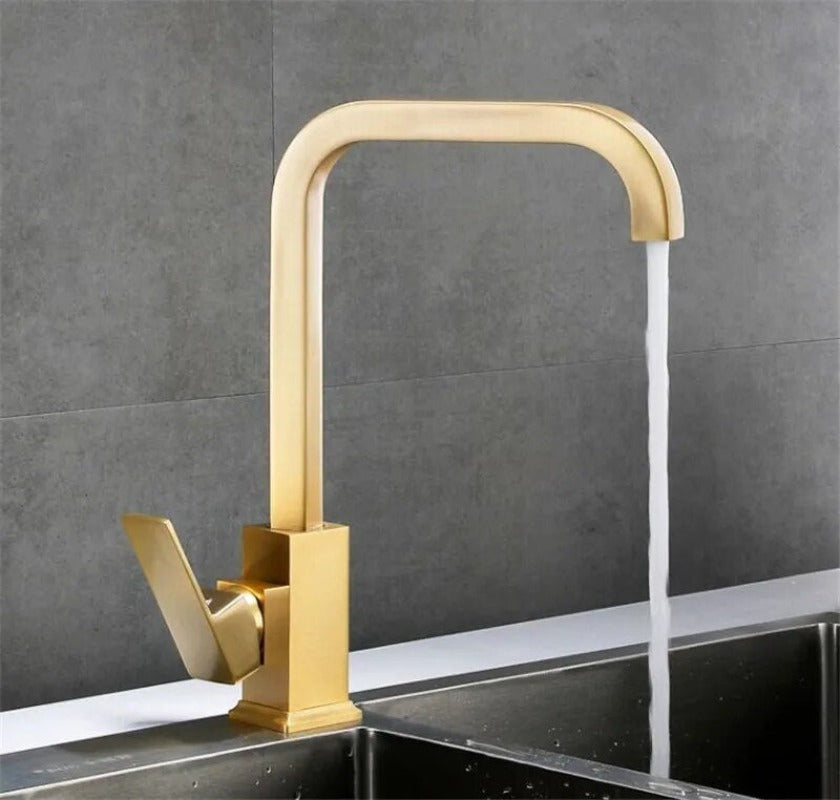 Arvo minimalist modern kitchen faucet with square base shown with running water in brushed gold finish