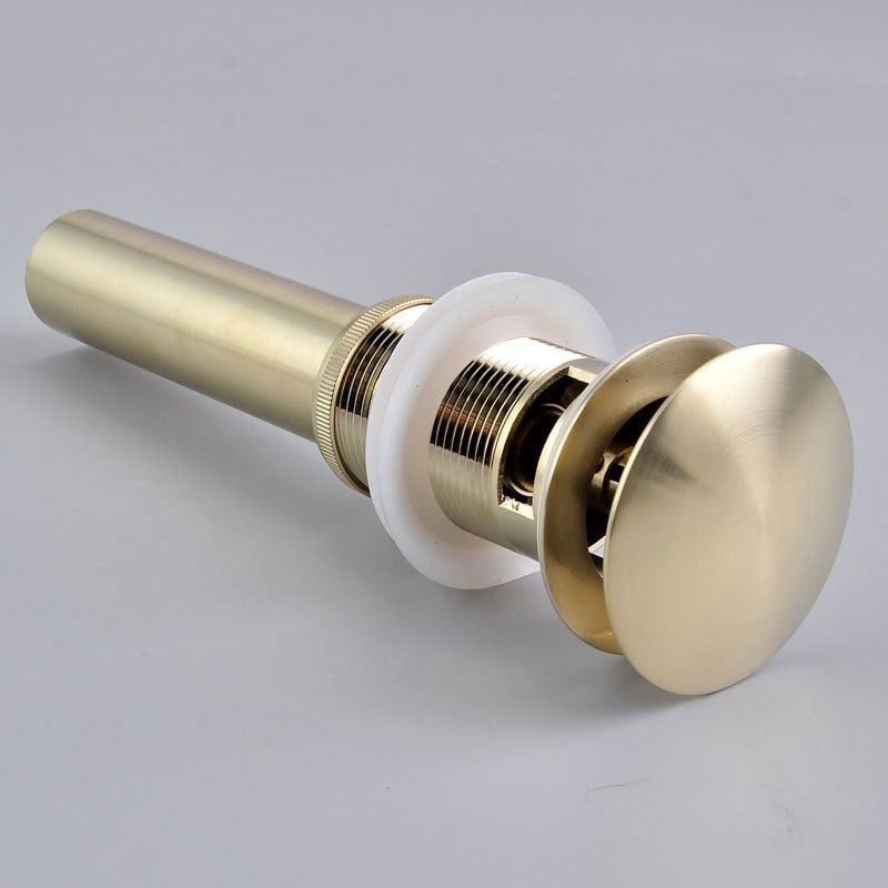 Detailed images of pop up, push down bathroom sink drain in brushed gold