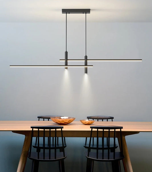 Modern Hanging Horizontal Light with two spotlights, 47 inches wide, black aluminum Frame shown illuminating a modern dining table