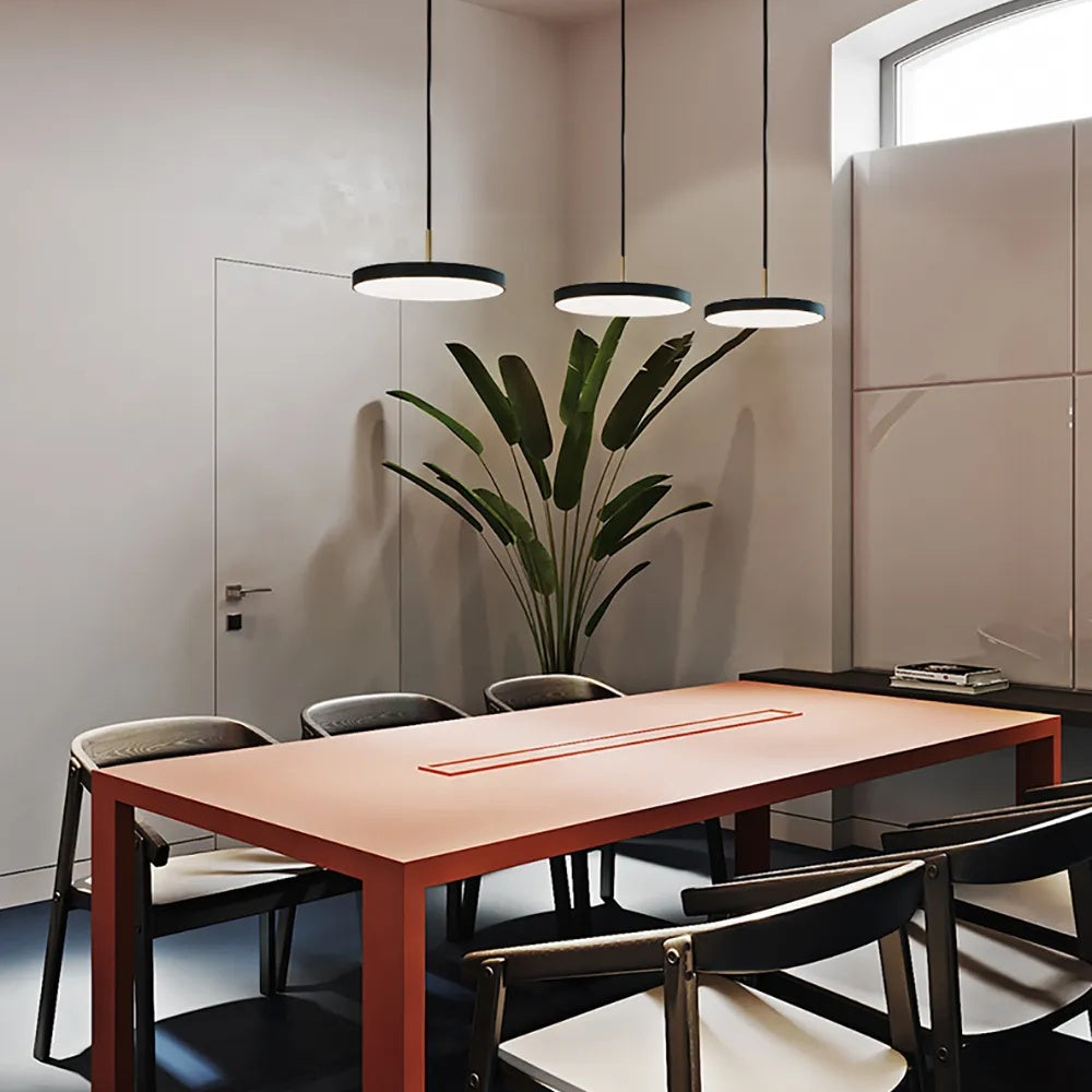 minimalisst hanging pendant lights in flat saucer shape shown hanging in a grouping of three in black  finish