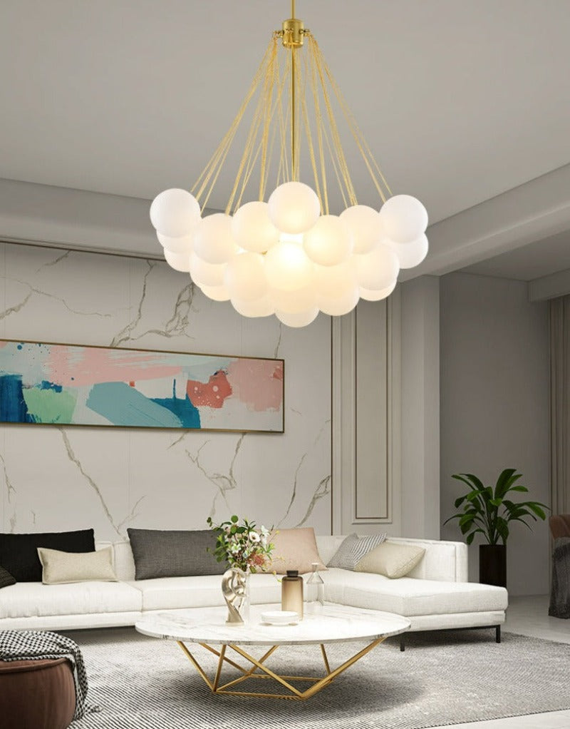 Large modern multi-globe bubble chandelier with gold hardware that looks like a cloud