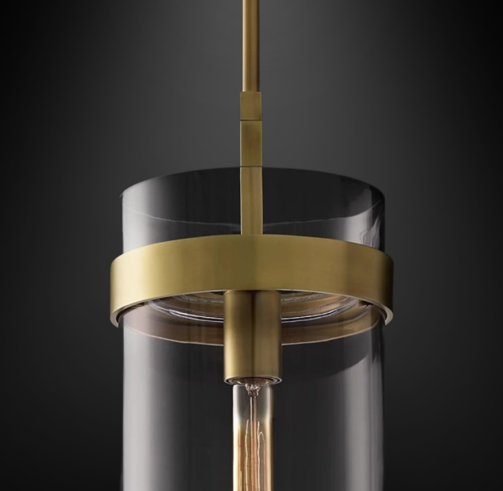 close up of modern cylindrical Glass Pendant with brushed gold hardware