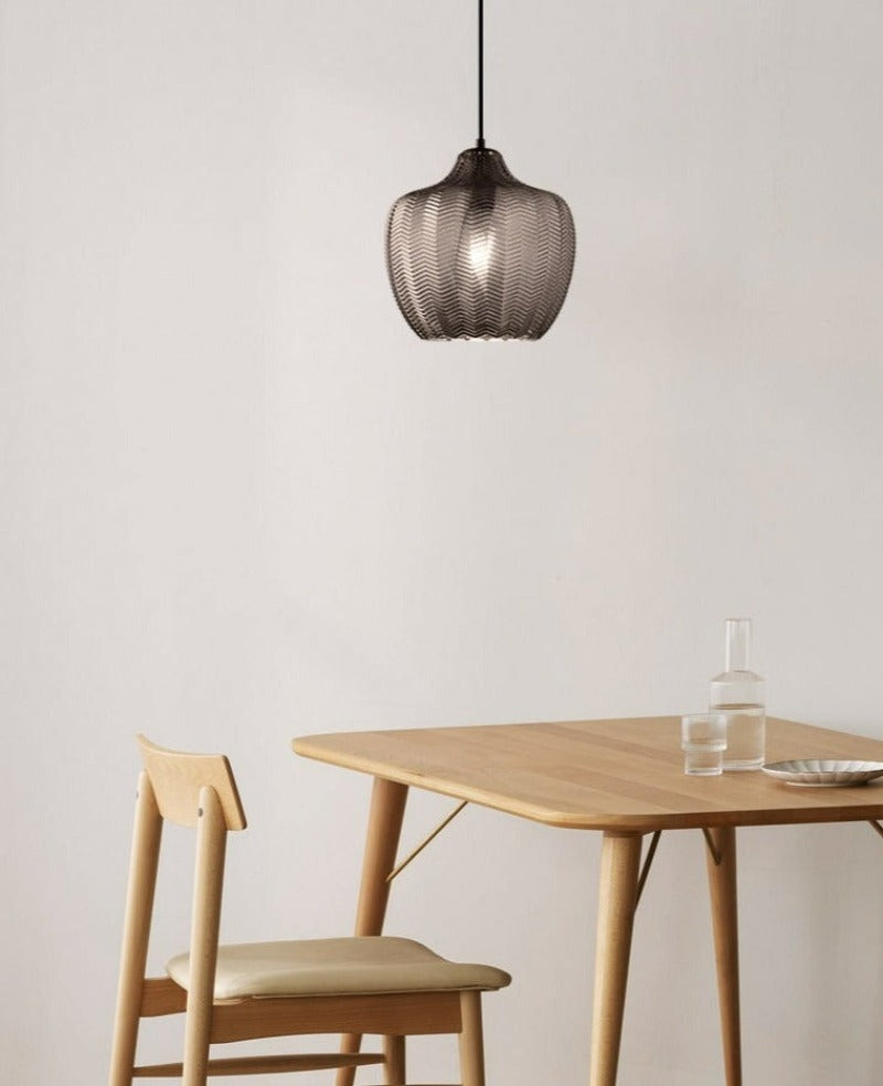 Chevron Patterned Textured Glass Pendant Light hanging over kitchen tablein smoky grayTint