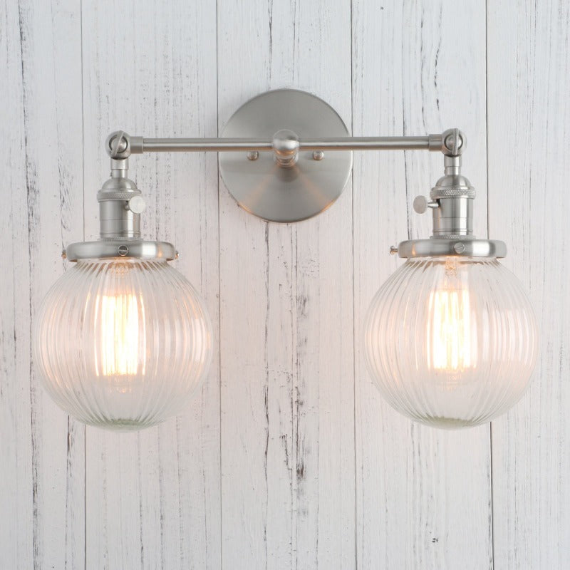 Vintage Double Wall Sconce with clear ribbed glass globes shown in nickel finish shown with lights on