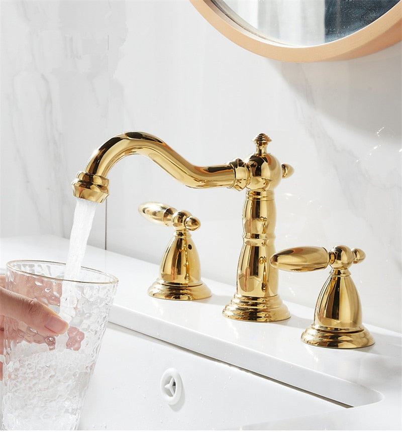 close up view of elegant gold widespread bathroom faucet