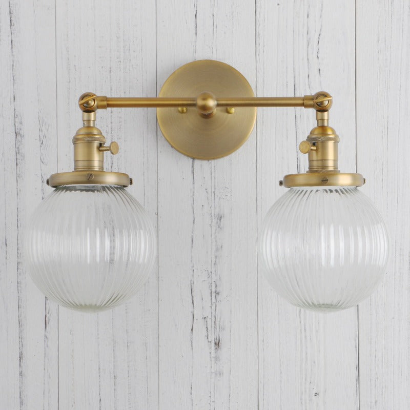 Vintage Double Wall Sconce with clear ribbed glass globes shown in brushed gold shown with light off