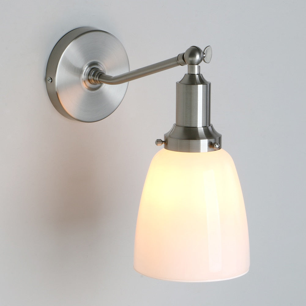 Vintage milk glass wall sconce shown in brushed nickel finish in the on position