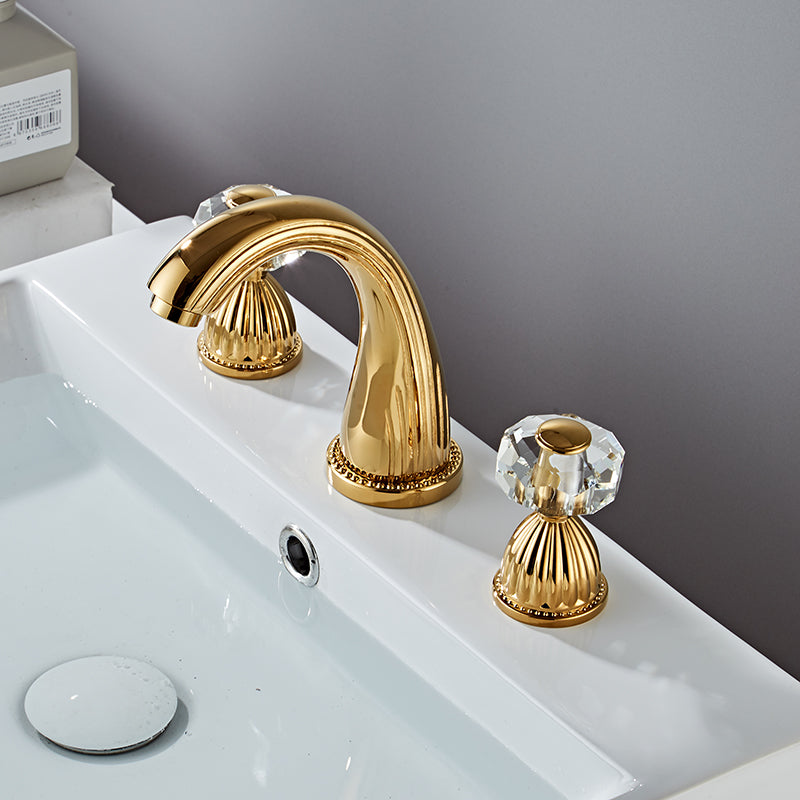 Gold bathroom faucet  with faceted crystal handles. Fluted Design. Deck mounted, three hole with two handles