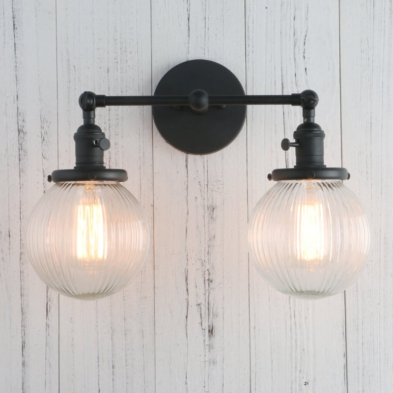 Vintage Double Wall Sconce with clear ribbed glass globes shown in black with lights on