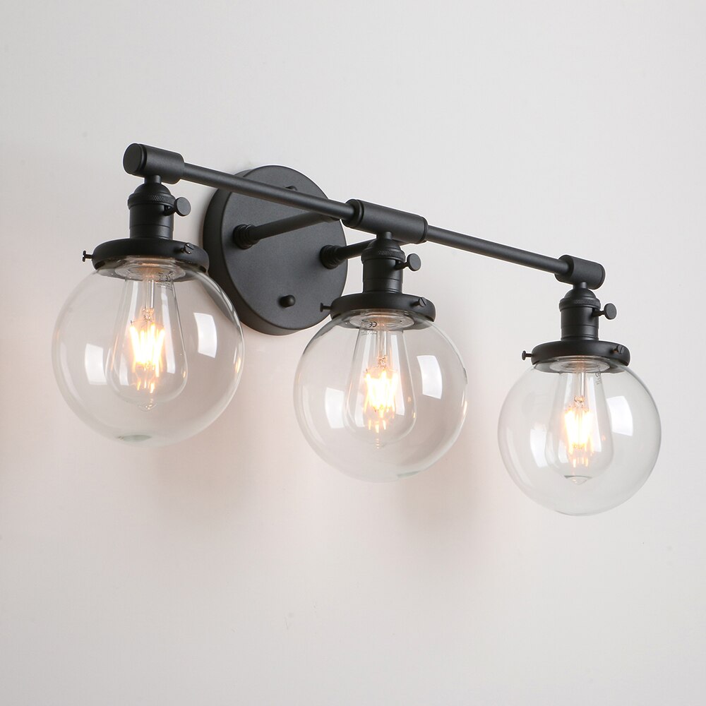 Three Light Bathroom Vanity Lighting with Clear Glass Globes shown in matte black at an angle