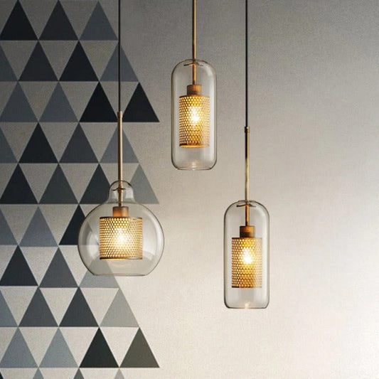 clear glass pendant lights with interior honeycomb shade shown in brushed gold finish