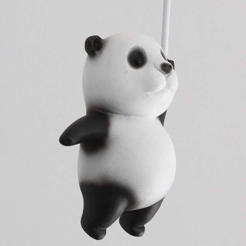 Close up view of panda hanging from a balloon ceiling light