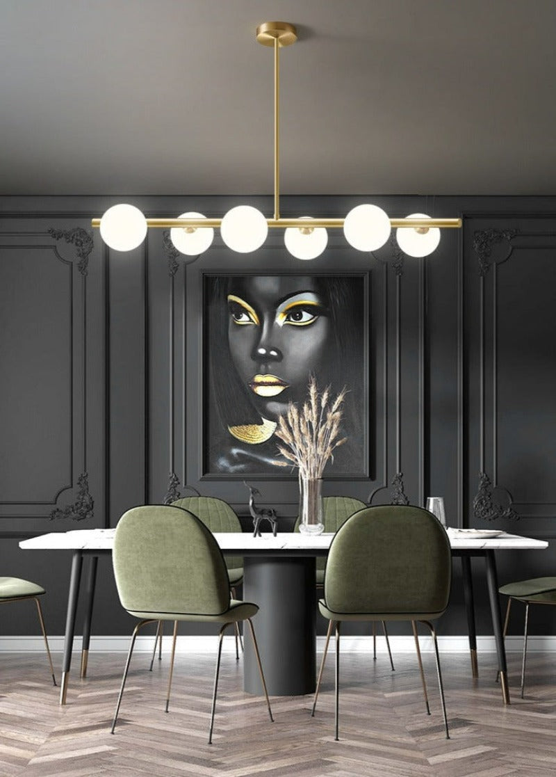 six globe modern horizontal chandelier shown over a dining table