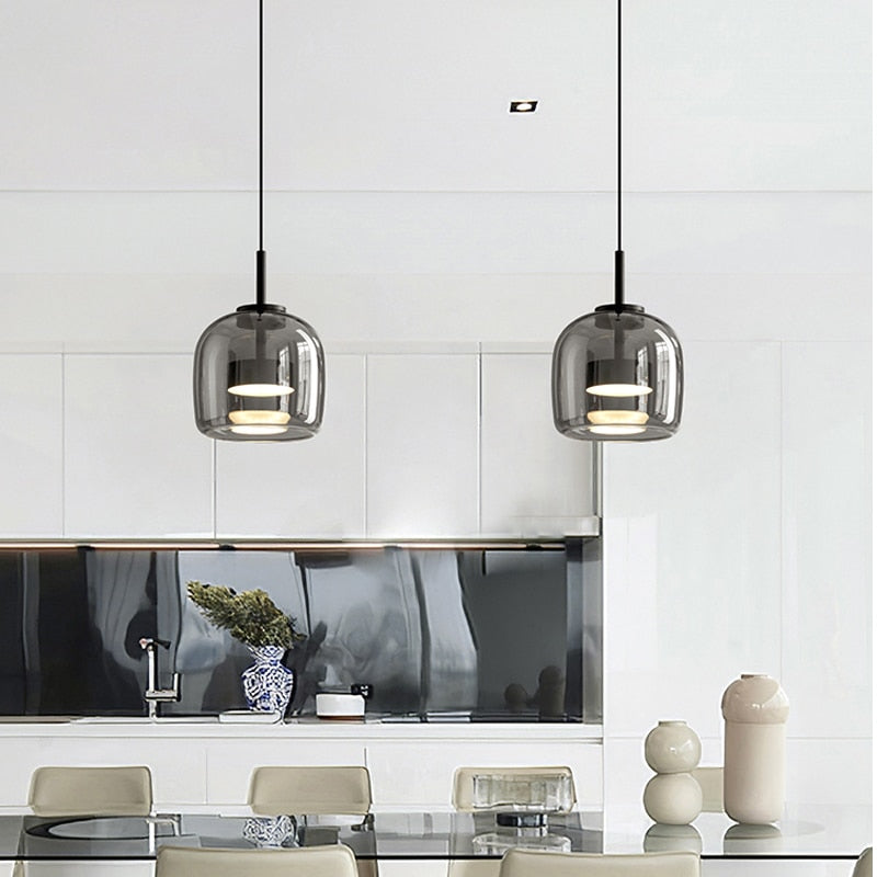 Modern pendant lighting with reflective smoky grey shade shown over a dining room table