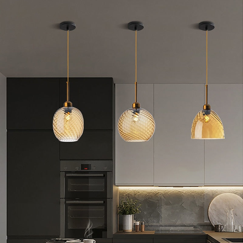 Selection of three pendant lights with amber shades