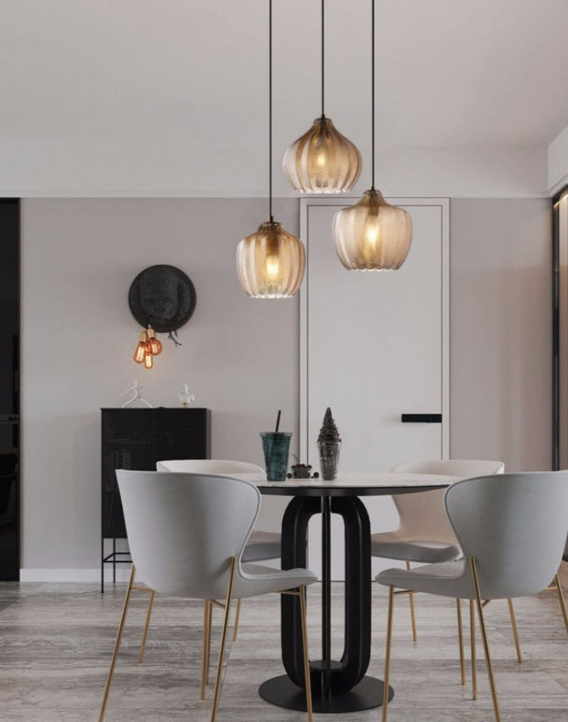 Chevron Patterned Textured Glass Pendant Lights in Amber Tint shown over dining room table