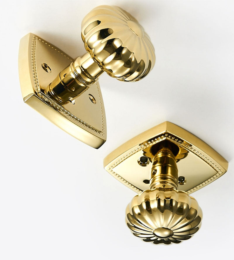 Close up view of interior and exterior Brass Privacy Door Knob with scalloped edges for bedroom or bathroom doors