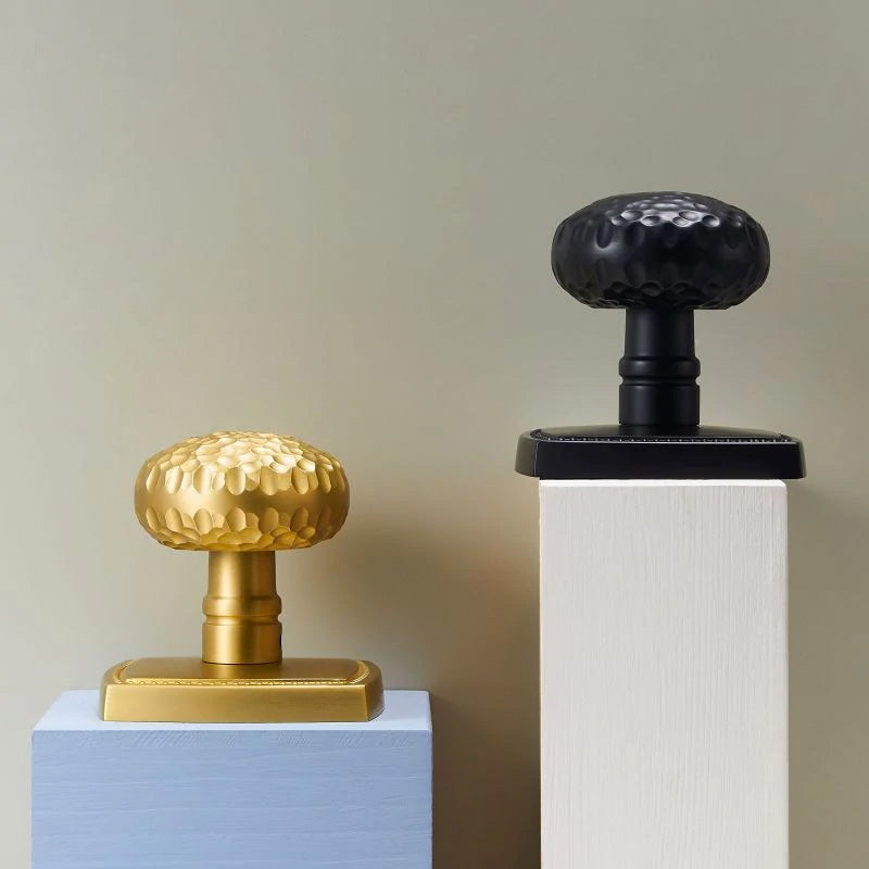 Brass privacy doorknob set with hammered finish and black privacy doorknob set with hammered finish  shown next to each other for comparison
