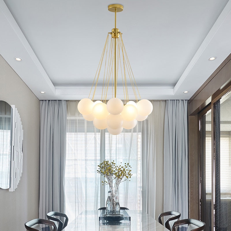 Smallcontemporary Bubble Chandelier with gold Hardware shown over a confernce table