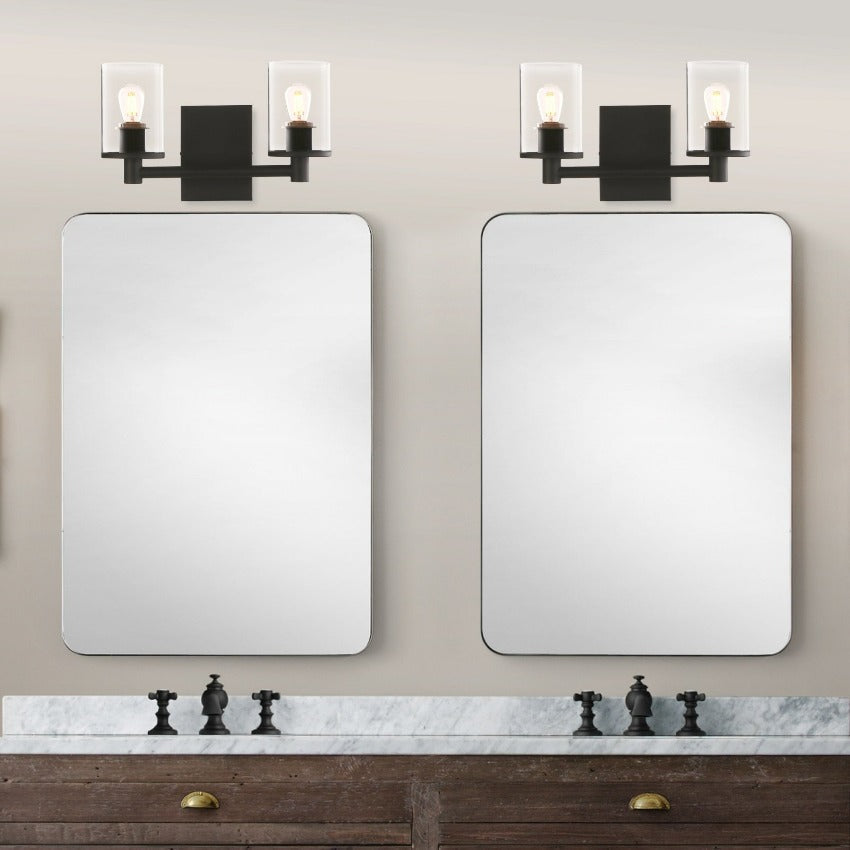 minimalist black double wall sconce shown above vanity mirror
