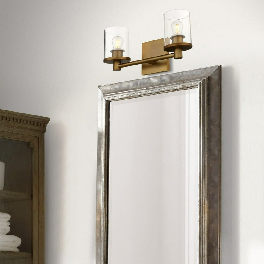 minimalist double wall sconce shown above vanity mirror