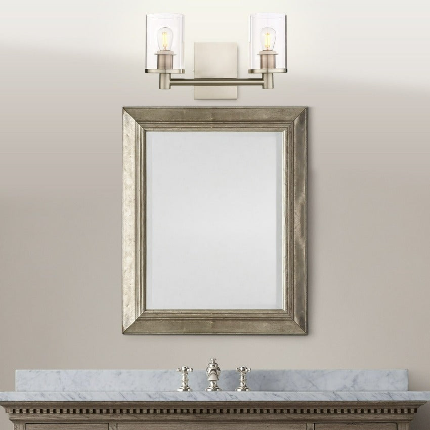 minimalist double wall sconce in brushed nickel shown above vanity mirror