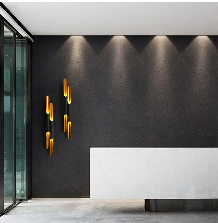 Double black and gold wall sconces displayed on wall