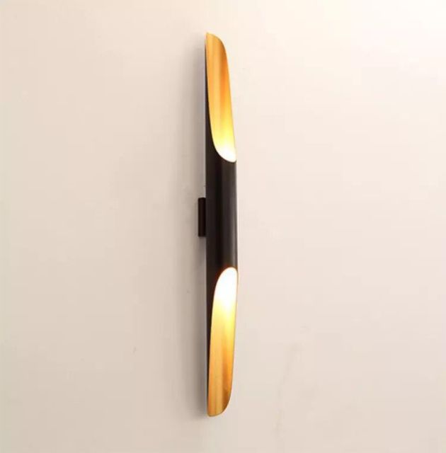 single black and gold wall sconces displayed on wall