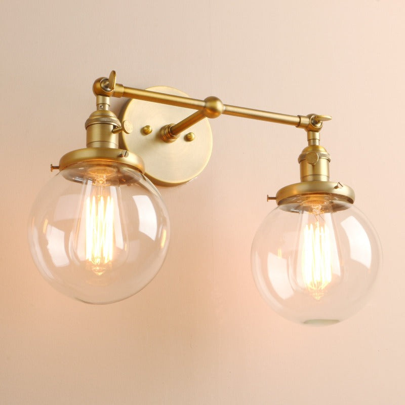 farmhouse Style Double Globe Wall Sconce in Brushed Gold Finish shown on and at an angle