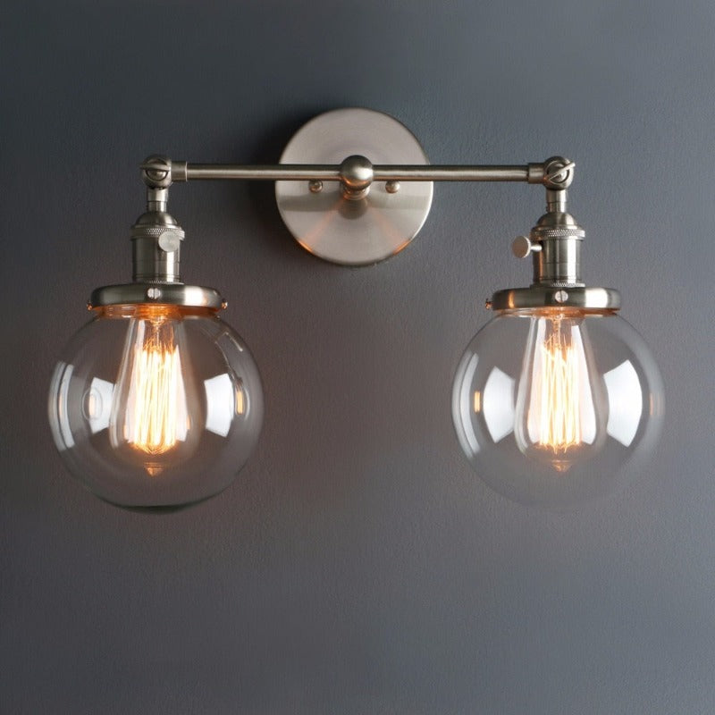 farmhouse Style Double Globe Edison Bulb Wall sconce shown in brushed nickel finish in the on position