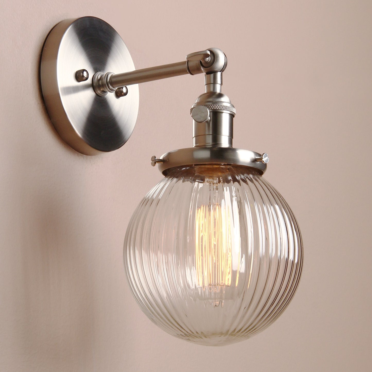 Farmhouse wall sconce with ribbed clear glass globe shown in brushed nickel hardware