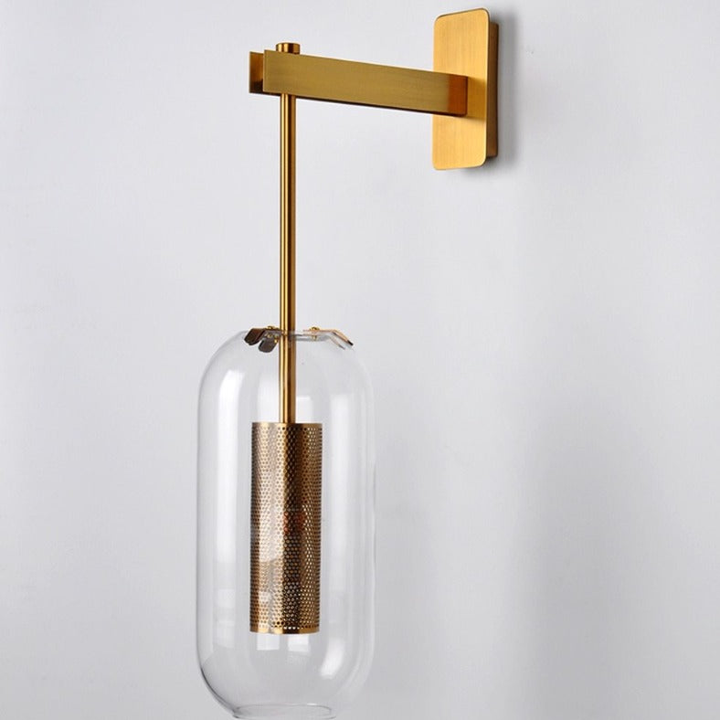 Modern brass and glass wall sconce with oblong glass shade