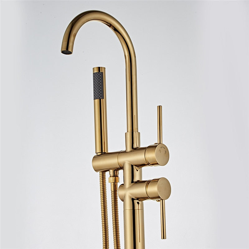 Close up of brushed gold freestanding floor mounted contemporary gooseneck tub filler for free standing bathtubs