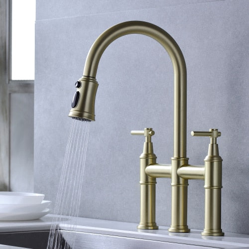 Contemporary three hole deck mounted Bridge kitchen faucet with pull down sprayer in brushed Gold