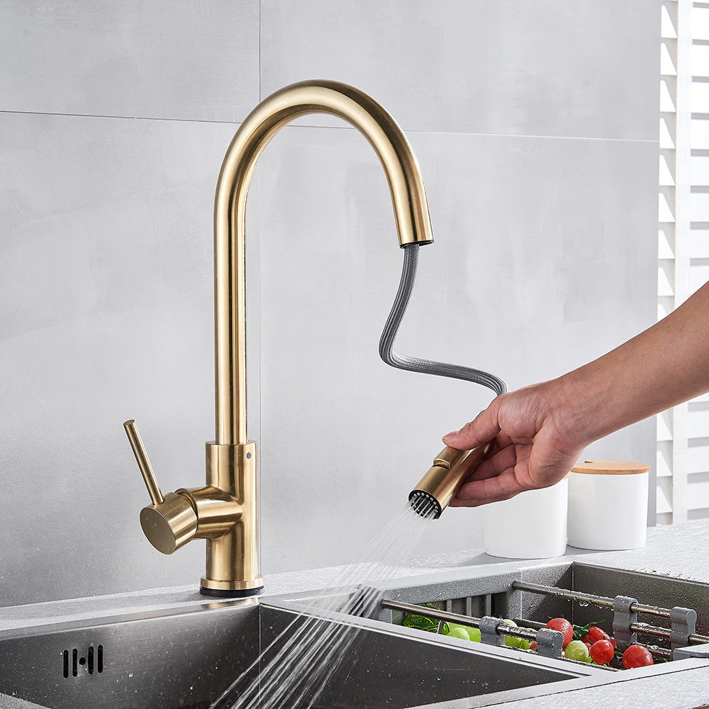Touch sensor kitchen faucet shown in use with pull out sprayer