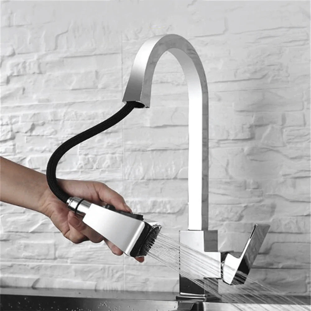 modern square kitchen faucet with pull down sprayer shown in use