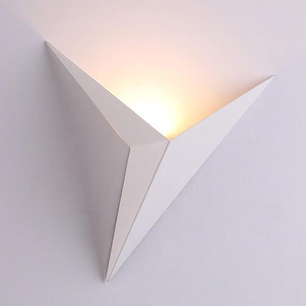 White geometric wall sconce shown against a white wall